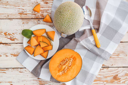 Plate with sweet cut melon on wooden backgroundの写真素材