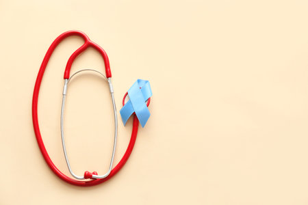 Blue ribbon and stethoscope on color background. Prostate cancer awareness conceptの写真素材