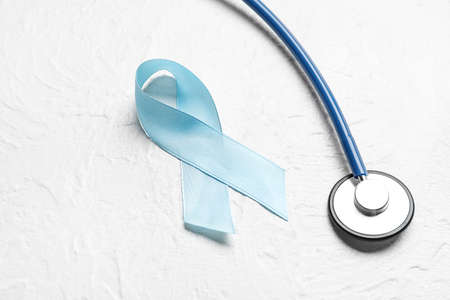 Blue ribbon and stethoscope on white background. Prostate cancer awareness conceptの写真素材
