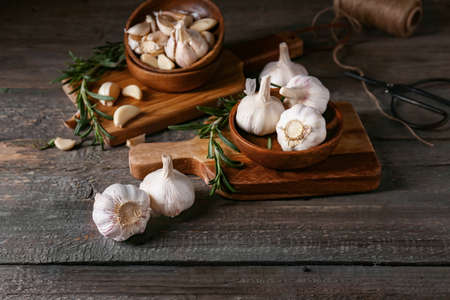 Bowls with fresh garlic on wooden backgroundの写真素材