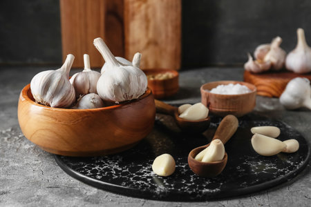 Bowl with fresh garlic on gray backgroundの写真素材