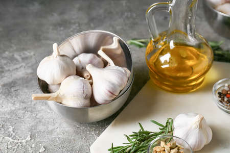 Bowl with fresh garlic on gray tableの写真素材
