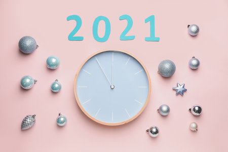 New Year composition with clock on color background