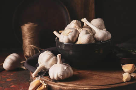 Bowl with fresh garlic on grunge background