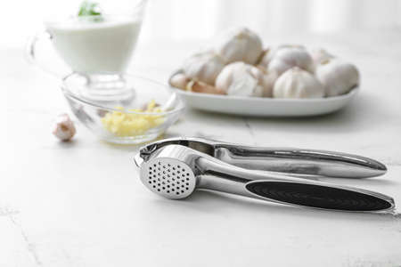 Garlic press on white background