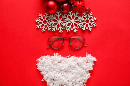 Santa Claus head made of Christmas decor on color backgroundの写真素材