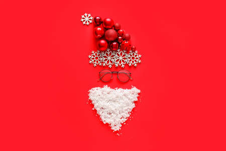 Santa Claus head made of Christmas decor on color backgroundの写真素材