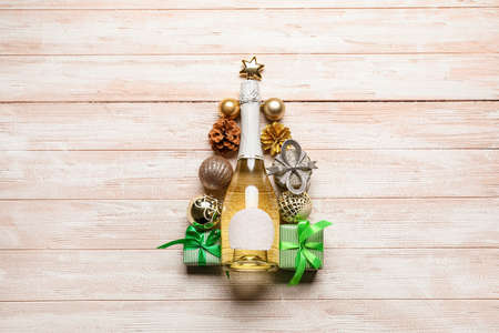 Beautiful Christmas decor with bottle of champagne on wooden backgroundの写真素材