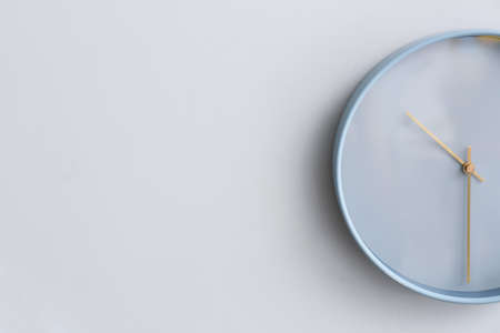Stylish clock hanging on light wall, closeupの写真素材