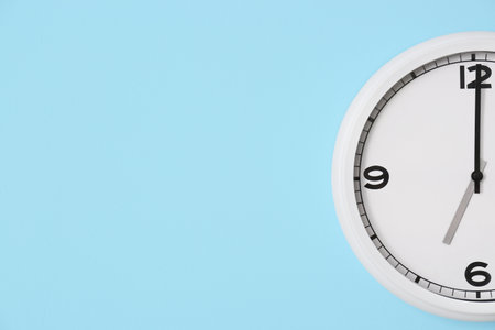 Stylish clock hanging on color wall, closeupの写真素材