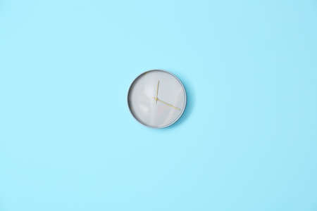 Stylish clock hanging on color wallの写真素材