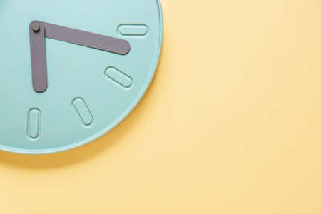 Stylish clock hanging on color wall, closeupの写真素材