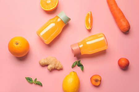 Healthy products and bottles of juice on color backgroundの写真素材