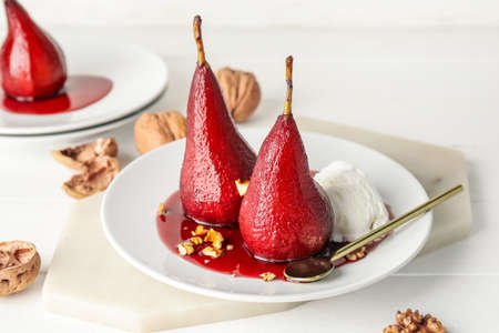 Composition with sweet poached pears and ice cream on light backgroundの写真素材