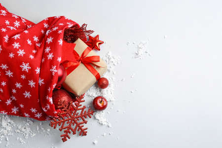Santa Claus bag full of gifts on light backgroundの写真素材