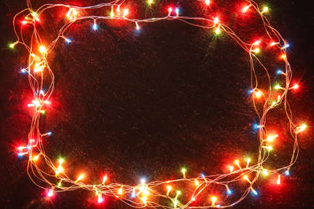 Glowing Christmas lights on dark backgroundの写真素材