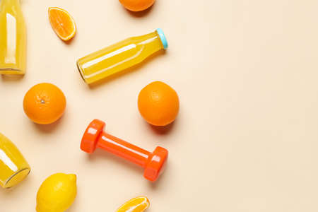 Fresh products and dumbbells on color background. Diet conceptの写真素材