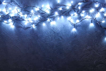 Glowing Christmas lights on dark backgroundの写真素材