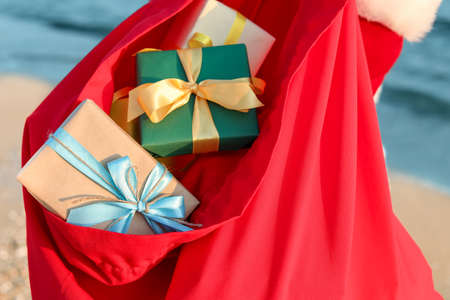 Santa Claus bag with gifts on beach, closeupの写真素材