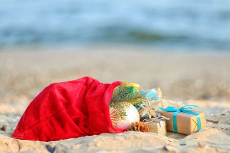 Santa Claus bag with gifts on beachの写真素材