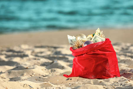 Santa Claus bag with gifts on beachの写真素材