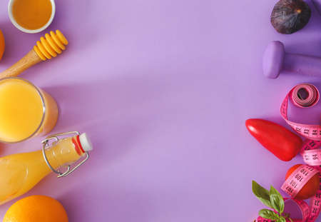 Fresh products with measuring tape and dumbbells on color background. Diet concept