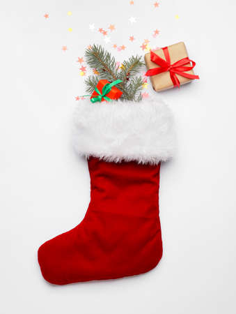 Christmas sock with gifts on white backgroundの写真素材