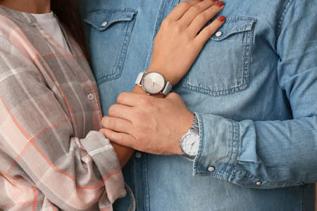 Happy young couple with watches, closeupの写真素材
