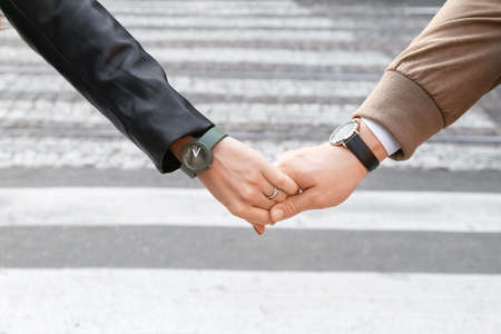 Young couple holding hands outdoors
