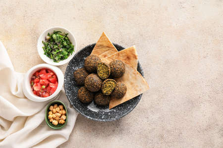 Plate with tasty falafel balls and pita on light backgroundの写真素材