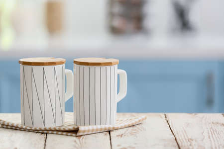 Cups on table in modern kitchenの写真素材