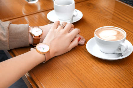 Young couple holding hands in cafe