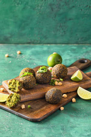 Board with tasty falafel balls and lime on color backgroundの写真素材