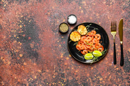 Plate with tasty shrimps on grunge backgroundの写真素材