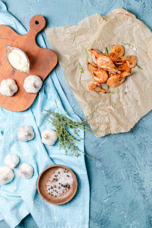 Parchment with tasty shrimps on color backgroundの写真素材