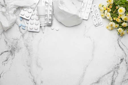 Bottle with drops, flowers and respirator on light backgroundの写真素材