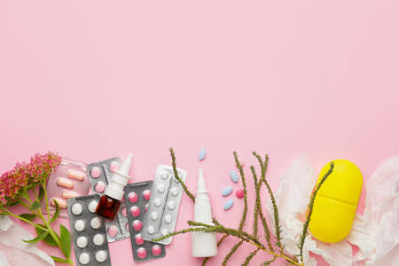 Composition with bottle of drops, flowers and pills on color background