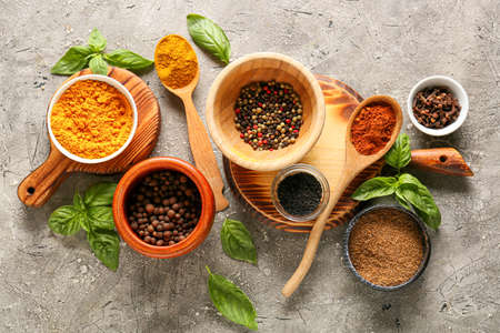 Bowls and spoons with different spices on dark backgroundの写真素材