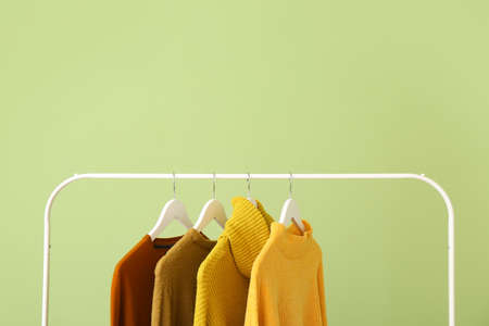 Rack with clothes on color backgroundの写真素材
