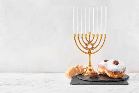 Menorah, dreidels and donuts for Hanukkah on white backgroundの写真素材