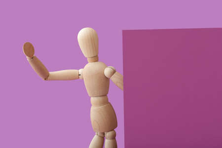 Wooden mannequin with blank poster on color backgroundの写真素材