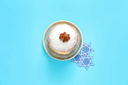 Tasty donut for Hanukkah on color backgroundの写真素材