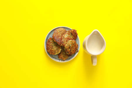 Tasty potato pancakes for Hanukkah on color background