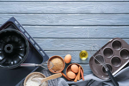 Set of kitchen utensils and ingredients for preparing bakery on dark wooden backgroundの写真素材