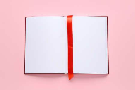Blank book with bookmark on color backgroundの写真素材