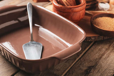 Baking dish and spatula on wooden background, closeupの写真素材