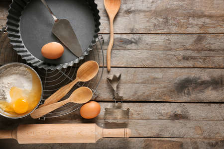 Set of kitchen utensils and ingredients for preparing bakery on wooden backgroundの写真素材
