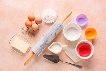Set of kitchen utensils and ingredients for preparing bakery on color backgroundの写真素材