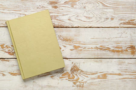 Blank book on wooden background