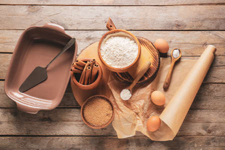 Set of kitchen utensils and ingredients for preparing bakery on wooden backgroundの写真素材